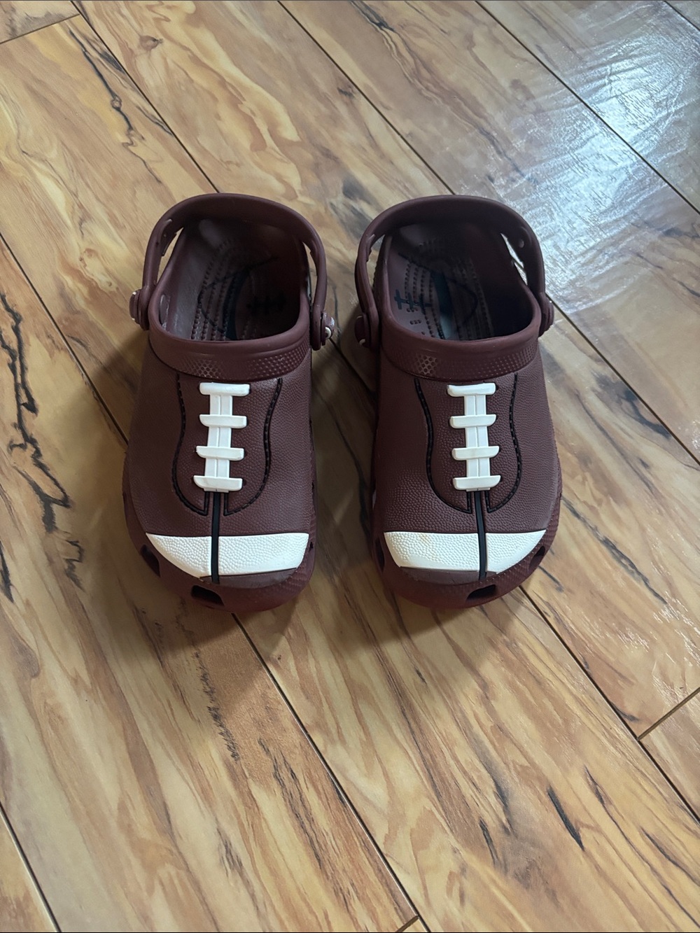 CROCS Kids Brown Clog with White Football Stitch Accents